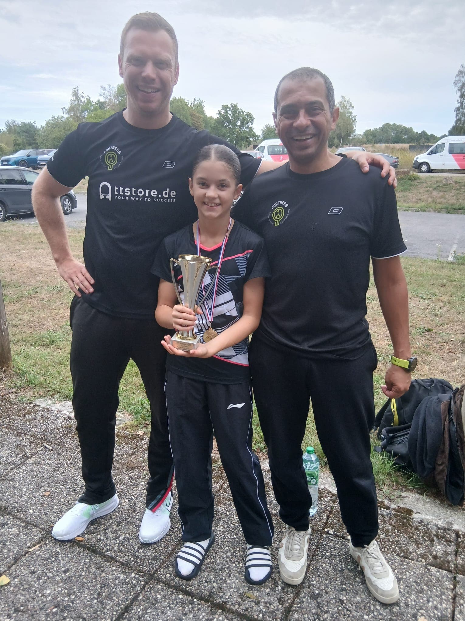 U13 champion Leni Heckel with Fortress coaches Momo and Mirko